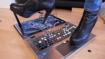 Crushing the slaves laptop under my ass and heels