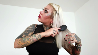 Blonde Tattooed Lady Combing Her Long Hair