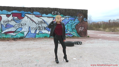 Sexy blonde Eva walks in leggings on a wasteland and shows her tight ass