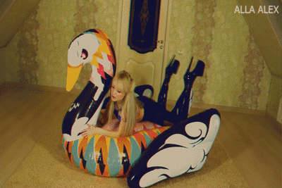 Alla is playing with a big inflatable swan.